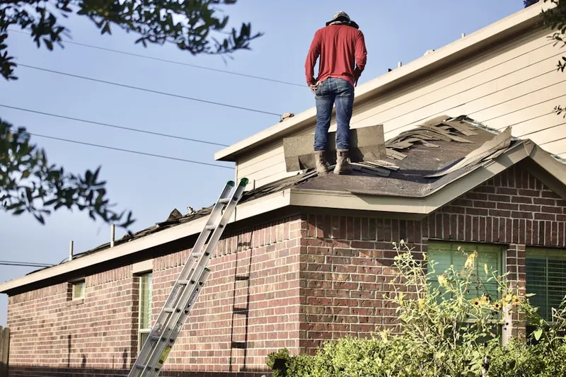 Professional roofer working on a residential roof in Waupun